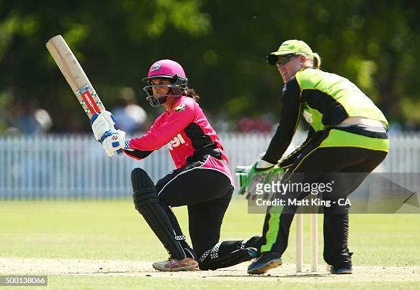 Lisa Sthalekar of the Sixers bats as Claire Koski of the Thunder keeps wicket during the Women's Big Bash League match between the Sydney Thunder and...