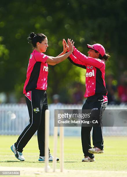 Marizanne Kapp of the Sixers celebrates with Lisa Sthalekar of the Sixers after taking the wicket of Rachel Haynes of the Thunder during the Women's...
