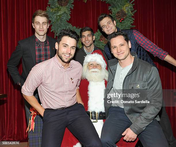 Actors Cameron Fuller, David Bernon and Jack Quaid, Actors Jack Falahee and Matt McGorry pose with Santa Claus at the Brooks Brothers holiday party...