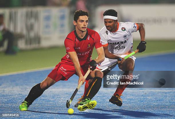 Tanguy Cosyns of Belgiumn vies with Birendra Lakra of India during the match between India and Belgium on day nine of The Hero Hockey League World...