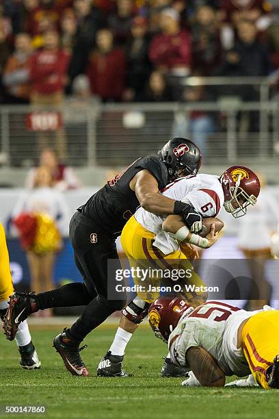 Quarterback Cody Kessler of the USC Trojans is sacked by defensive end Solomon Thomas of the Stanford Cardinal during the fourth quarter of the...