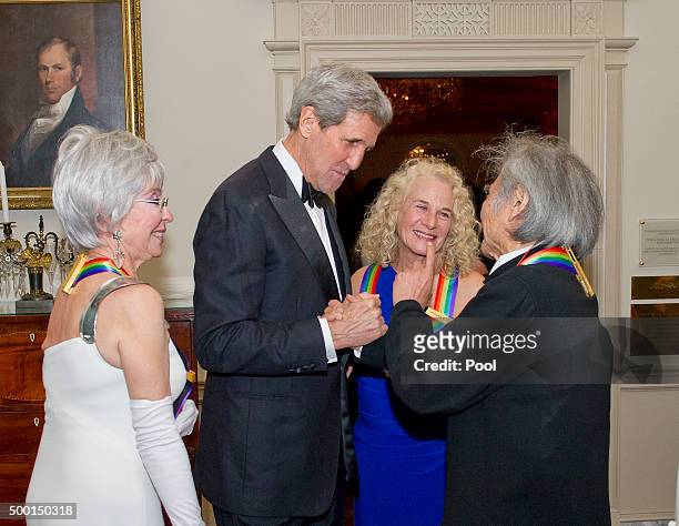 United States Secretary of State John F. Kerry, left center, shakes hands with conductor Seiji Ozawa, right, one of the five recipients of the 38th...