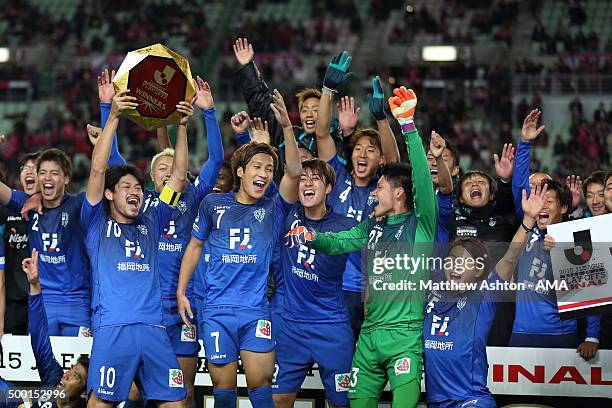 Hisashi Jogo of Avispa Fukuoka lifts the J2 Play Off Winners trophy as his team celebrate promotion to J1 after the J1 Promotion Play Off Final...