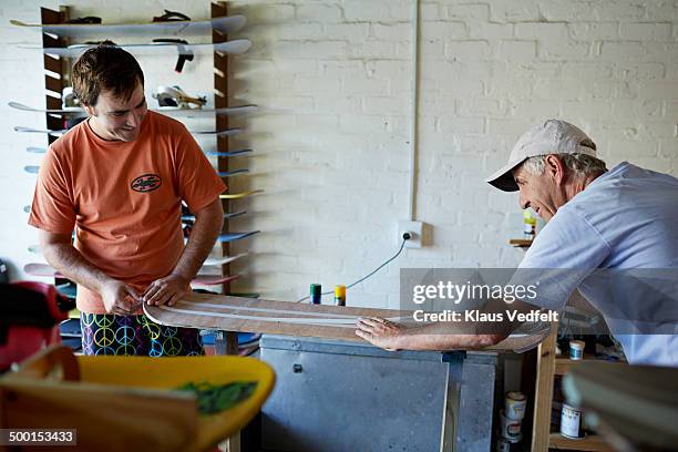 Father & son preparing a paintjob on a sandboard