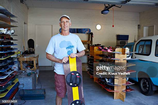 Mature man standing with his self made sandboard