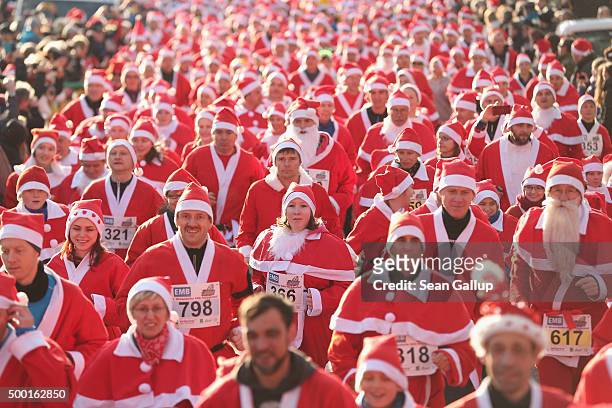 Participants dressed as Santa Claus start in the 7th annual Michendorf Santa Run on December 6, 2015 in Michendorf, Germany. A record 900 runners...