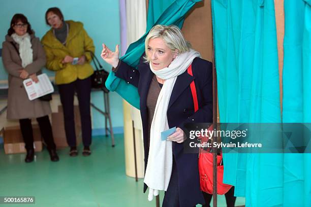 French Far-Right National Front President Marine Le Pen exits from a polling booth before voting for the first round of regional elections, on...