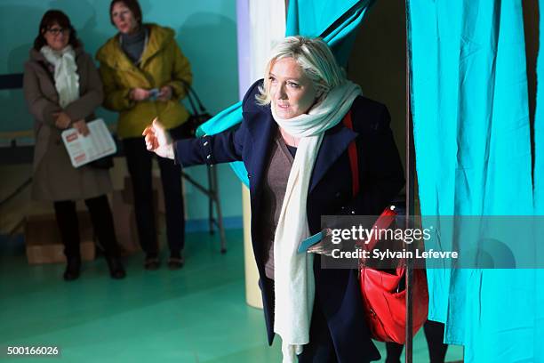 French Far-Right National Front President Marine Le Pen exits from a polling booth before voting for the first round of regional elections, on...