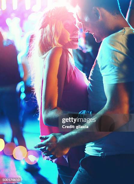 two people dancing at concert. - flirting stock pictures, royalty-free photos & images