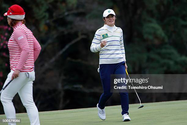 Ayaka Watanabe of the Ladies Professional Golf Association of Japan team, right, reacts after winning a match with Yoon-Ji Cho of the Korea Ladies...