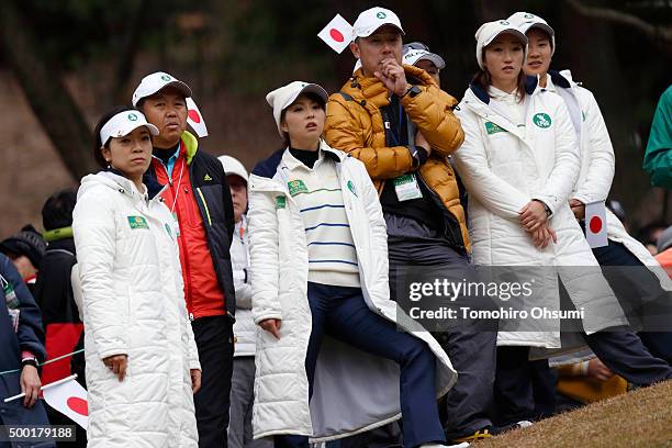 Members of the Ladies Professional Golf Association of Japan team, look at Ayaka Watanabe playing a shot, not pictured, on the 17th hole during the...