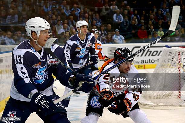 Christoph Schubert of Hamburg Freezers battles for the puck with Timm Wallace of Grizzly Wolfsburg during the DEL game between Hamburg Freezers and...