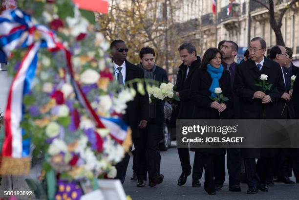 United Nations secretary general Ban Ki-moon and Paris mayor Anne Hidalgo arrive to lay flowers outside the Bataclan concert venue, one of the sites...