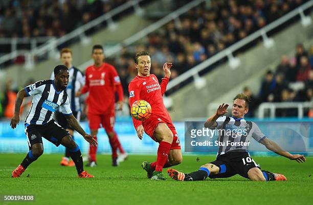 Lucas Leiva of Liverpool battles with Vurnon Anita and Siem de Jong of Newcastle United during the Barclays Premier League match between Newcastle...