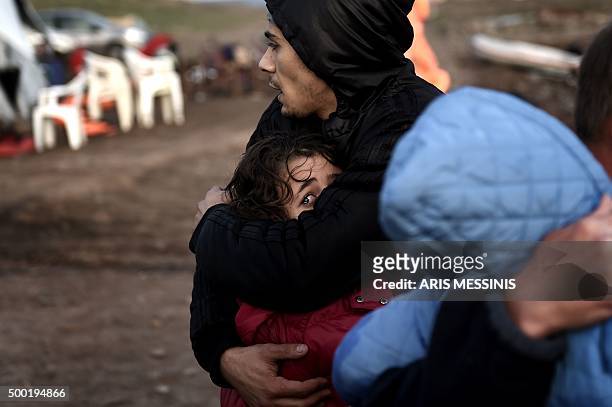 Refugees and migrants arrive to the Greek island of Lesbos after crossing the Aegean sea from Turkey, on December 4, 2015. / AFP / ARIS MESSINIS