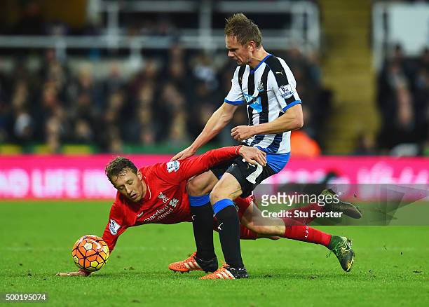 Siem de Jong of Newcastle United tangles with Lucas Leiva of Liverpool during the Barclays Premier League match between Newcastle United and...