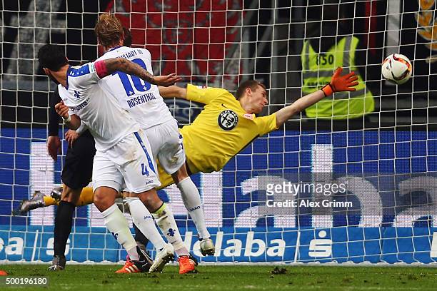 Aytac Sulu of Darmstadt scores his team's first goal against goalkeeper Lukas Hradecky of Frankfurt during the Bundesliga match between Eintracht...