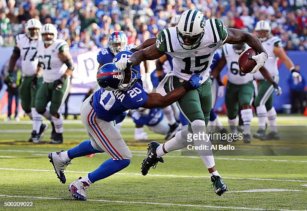 Brandon Marshall of the New York Jets runs with the ball against Prince Amukamara of the New York Giants at MetLife Stadium on December 6, 2015 in...