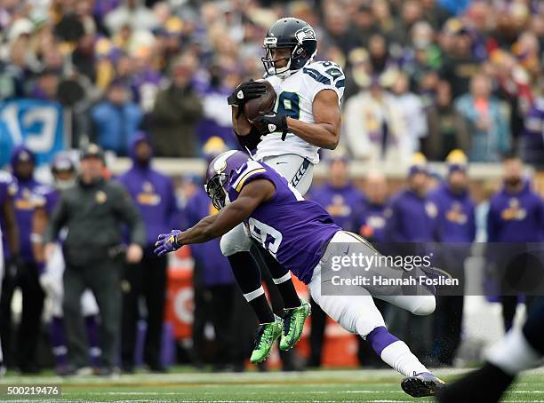 Xavier Rhodes of the Minnesota Vikings tackles Doug Baldwin of the Seattle Seahawks after a reception during the second quarter of the game on...