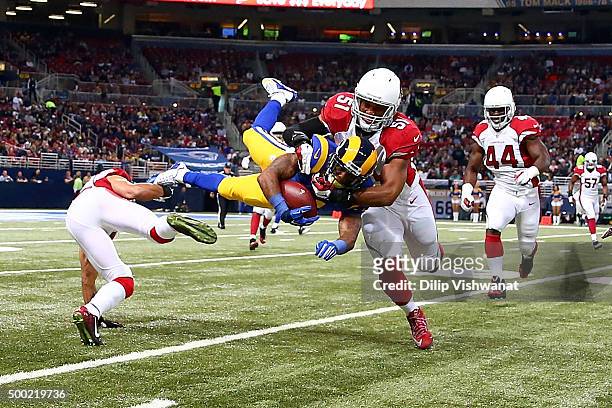 Tavon Austin of the St. Louis Rams is tackled by Kevin Minter of the Arizona Cardinals in the first quarter at the Edward Jones Dome on December 6,...