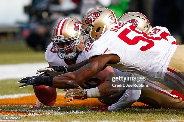 Bruce Miller and Eli Harold of the San Francisco 49ers scramble to grab the football in the second quarter against the Chicago Bears at Soldier Field...