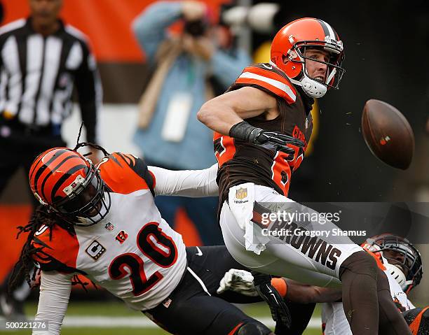 Brian Hartline of the Cleveland Browns can't come down with a second quarter reception next to Reggie Nelson of the Cincinnati Bengals at FirstEnergy...