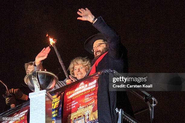 State Minister Monika Gruetters and Rabbi Yehuda Teichtal light the Hanukkah menorah lighting at a public Menorah ceremony near the Brandenburg Gate...