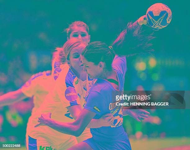 Tunisia's Mouna Chabbah is tackled by Denmark's Anne Mette Pedersen during the World Women's Handball Championship group A match between Denmark and...