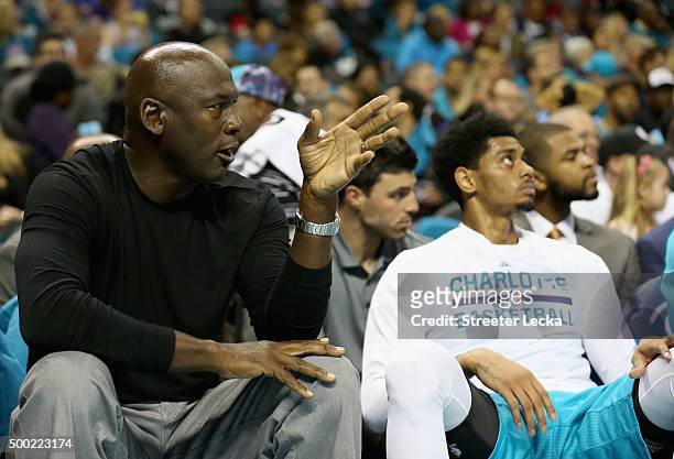 Michael Jordan, owner of the Charlotte Hornets sits on the bench with Jeremy Lamb of the Charlotte Hornets during their game at Time Warner Cable...