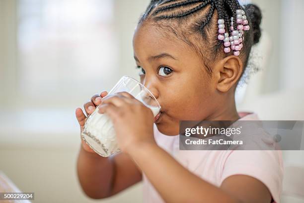 little girl drinking milk - drink milk stock pictures, royalty-free photos & images