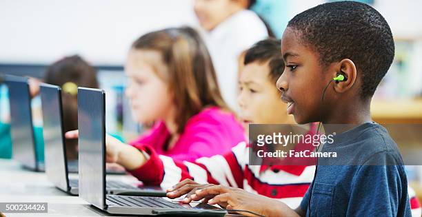 listening to music from the web - classroom technology stock pictures, royalty-free photos & images