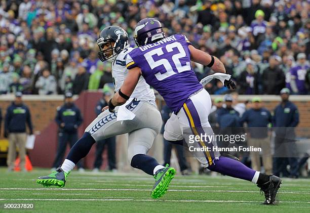 Russell Wilson of the Seattle Seahawks avoids a sack by Chad Greenway of the Minnesota Vikings during the fourth quarter of the game on December 6,...