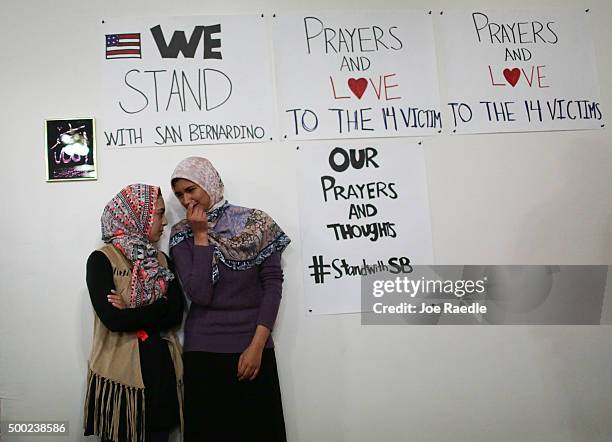 Khadija Zadeh and Noora Siddiqui stand together as they attend an interfaith service at the Islamic Community Center of Redlands for the victims of...