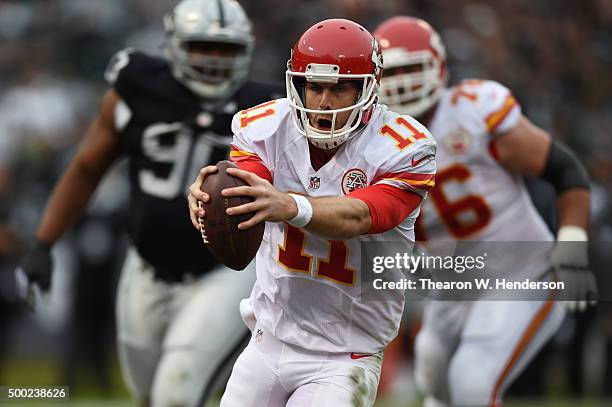 Alex Smith of the Kansas City Chiefs runs for a three-yard touchdown against the Oakland Raiders during their NFL game at O.co Coliseum on December...