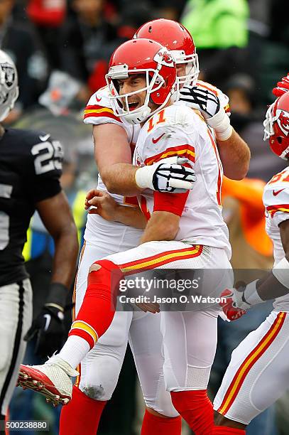 Alex Smith of the Kansas City Chiefs celebrates with Eric Fisher after a three-yard touchdown against the Oakland Raiders during their NFL game at...