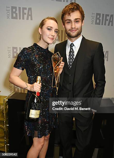 Saoirse Ronan, winner of the Best Actress award for "Brooklyn", and presenter Douglas Booth pose at the Moet British Independent Film Awards 2015 at...