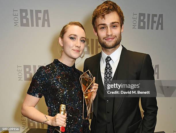 Saoirse Ronan, winner of the Best Actress award for "Brooklyn", and presenter Douglas Booth pose at the Moet British Independent Film Awards 2015 at...