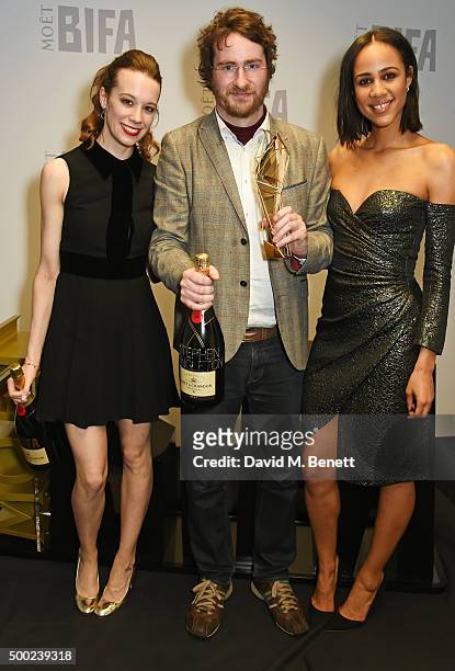 Stephen Fingleton , winner of the Douglas Hickox Award for Debut Director for "The Survivalist", and presenters Chloe Pirrie and Zawe Ashton pose at...