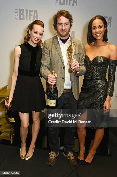 Stephen Fingleton , winner of the Douglas Hickox Award for Debut Director for "The Survivalist", and presenters Chloe Pirrie and Zawe Ashton pose at...