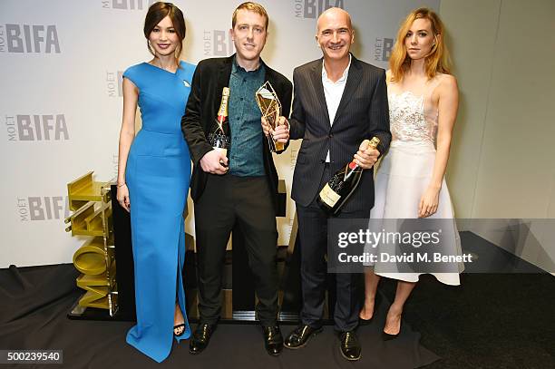 Andrew de Lotbiniere and Paul Katis, winners of the Producer of the Year Award for "Kajaki: The True Story", pose with presenter Gemma Chan and...