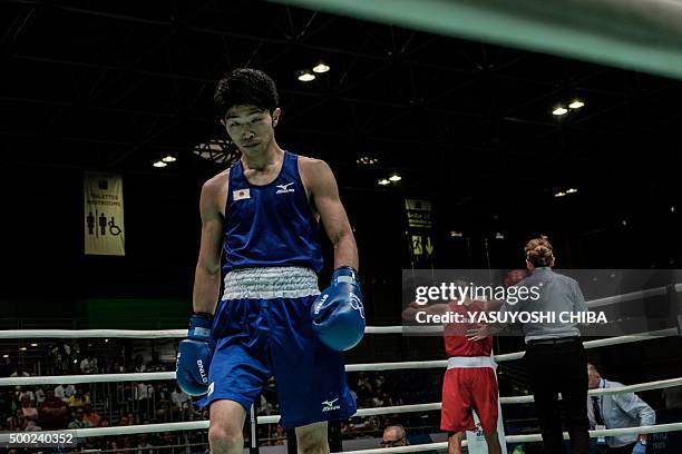 Japan's Ryomei Tanaka walks to a corner after a referee stops Brazil's Juliao Henriques Neto during the Men's Boxing Fly match as a test event for...