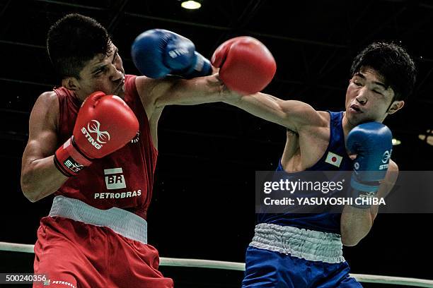 Japan's Ryomei Tanaka and Brazil's Juliao Henriques Neto fight during the Men's Boxing Fly match as a test event for Rio 2016 Olympic games at...