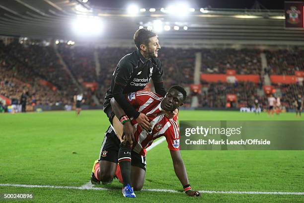 Adam Lallana of Liverpool tangles with Victor Wanyama of Southampton during the Capital One Cup Quarter Final between Southampton and Liverpool at St...