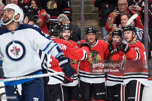 Marian Hossa of the Chicago Blackhawks celebrates with teammates, including Brent Seabrook, Teuvo Teravainen and Jonathan Toews, after scoring...