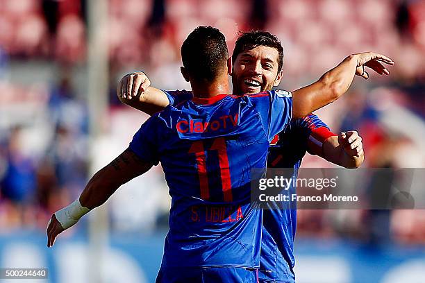 Sebastian Ubilla of U de Chile celebrates with teammates after scoring the first goal of his team during a match between U de Chile and Huachipato as...