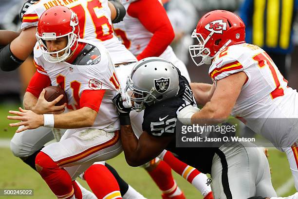 Alex Smith of the Kansas City Chiefs is sacked by Khalil Mack of the Oakland Raiders during their NFL game at O.co Coliseum on December 6, 2015 in...