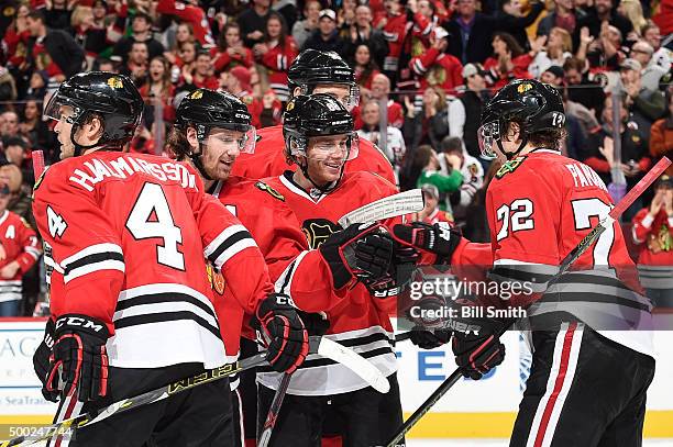 Patrick Kane of the Chicago Blackhawks celebrates with Duncan Keith and Artemi Panarin after assisting Panarin's goal to break the Chicago Blackhawks...