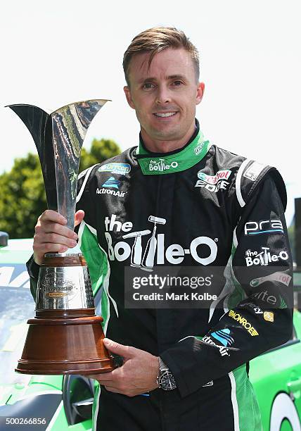 Mark Winterbottom poses with the Championship trophy at the reveal of his new-look 2016 race car at Doltone House on December 7, 2015 in Sydney,...