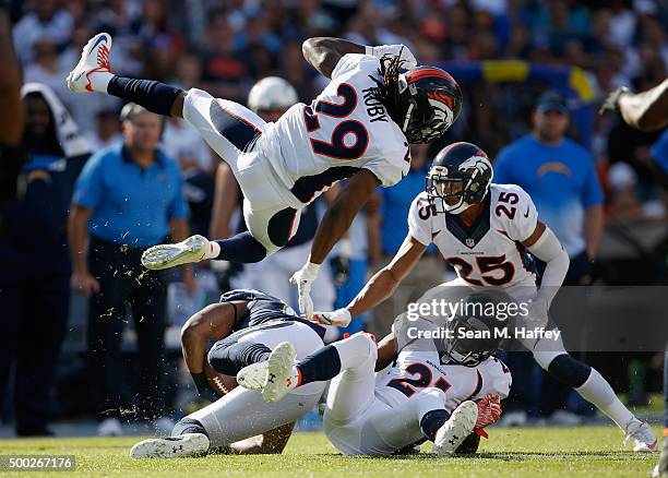 Aqib Talib of the Denver Broncos, Chris Harris of the Denver Broncos, and Bradley Roby of the Denver Broncos tackle Antonio Gates of the San Diego...