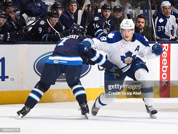 Matt Frattin of the Toronto Marlies is held up by Josh Morrissey of the Manitoba Moose during AHL game action on December 6, 2015 at the Air Canada...